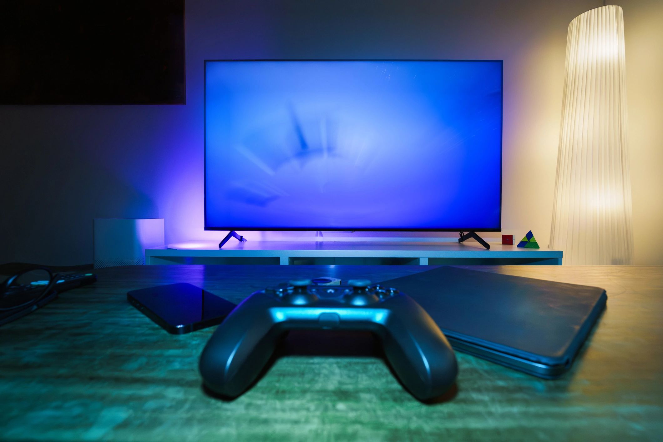 Game controller on table in a home entertainment setup.