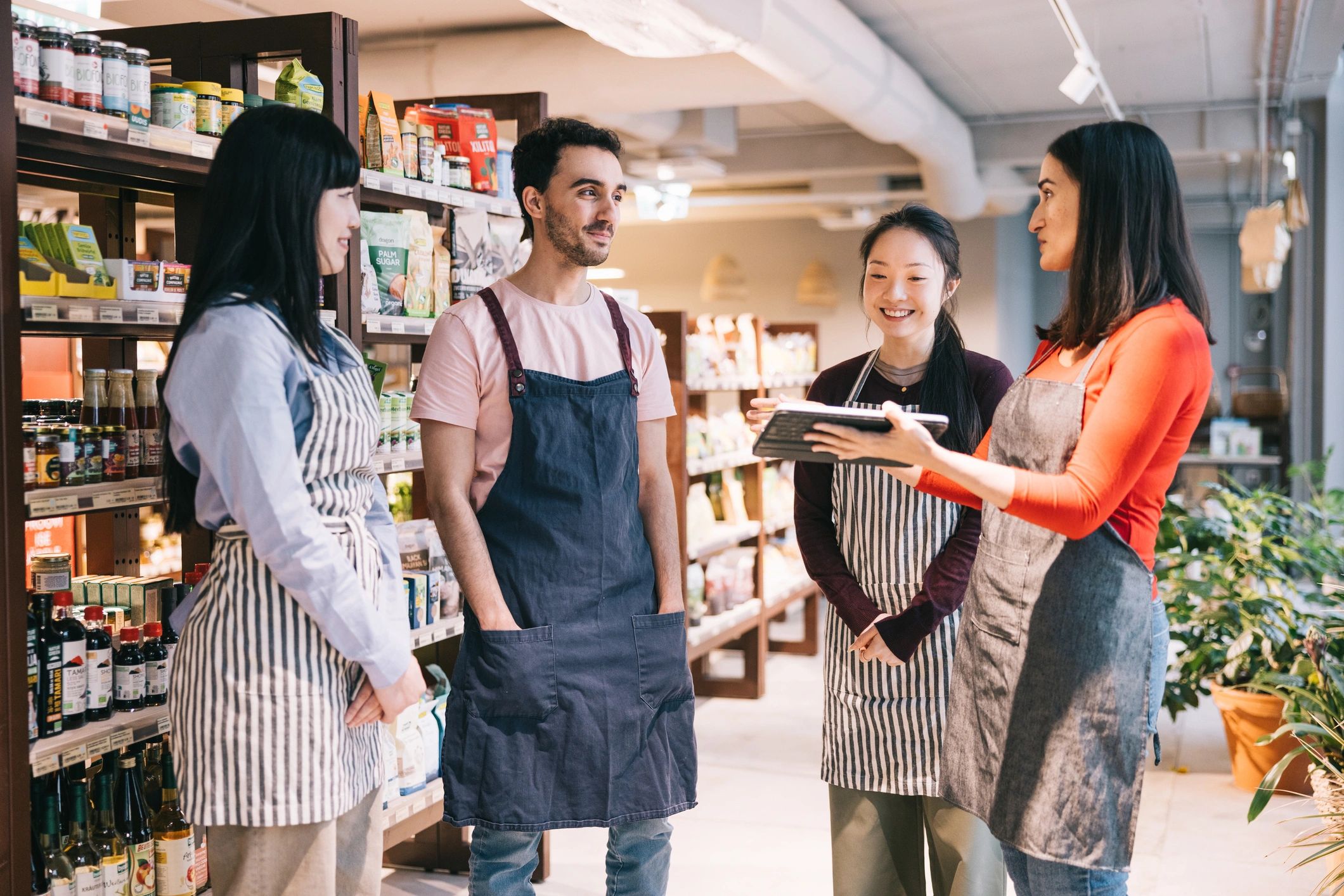 Team lead speaking with employees in a shop setting