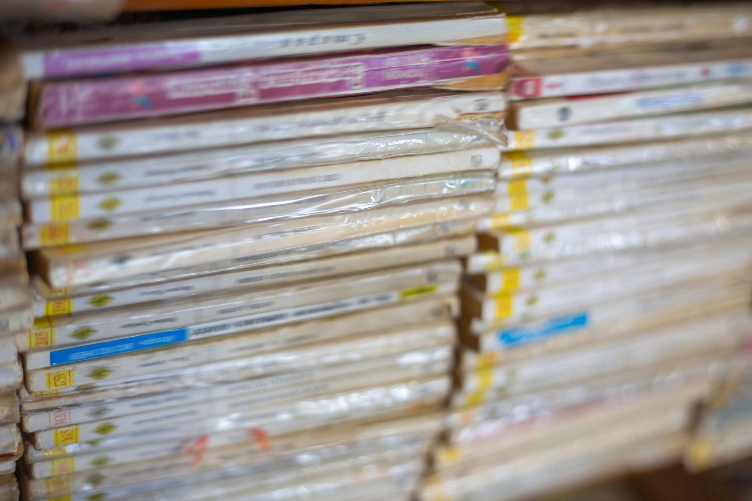 Stacked game cases and collectibles on a shelf.